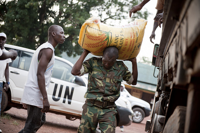 UN Worker Carrying bulk grains