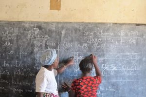 student and teacher at a blackboard